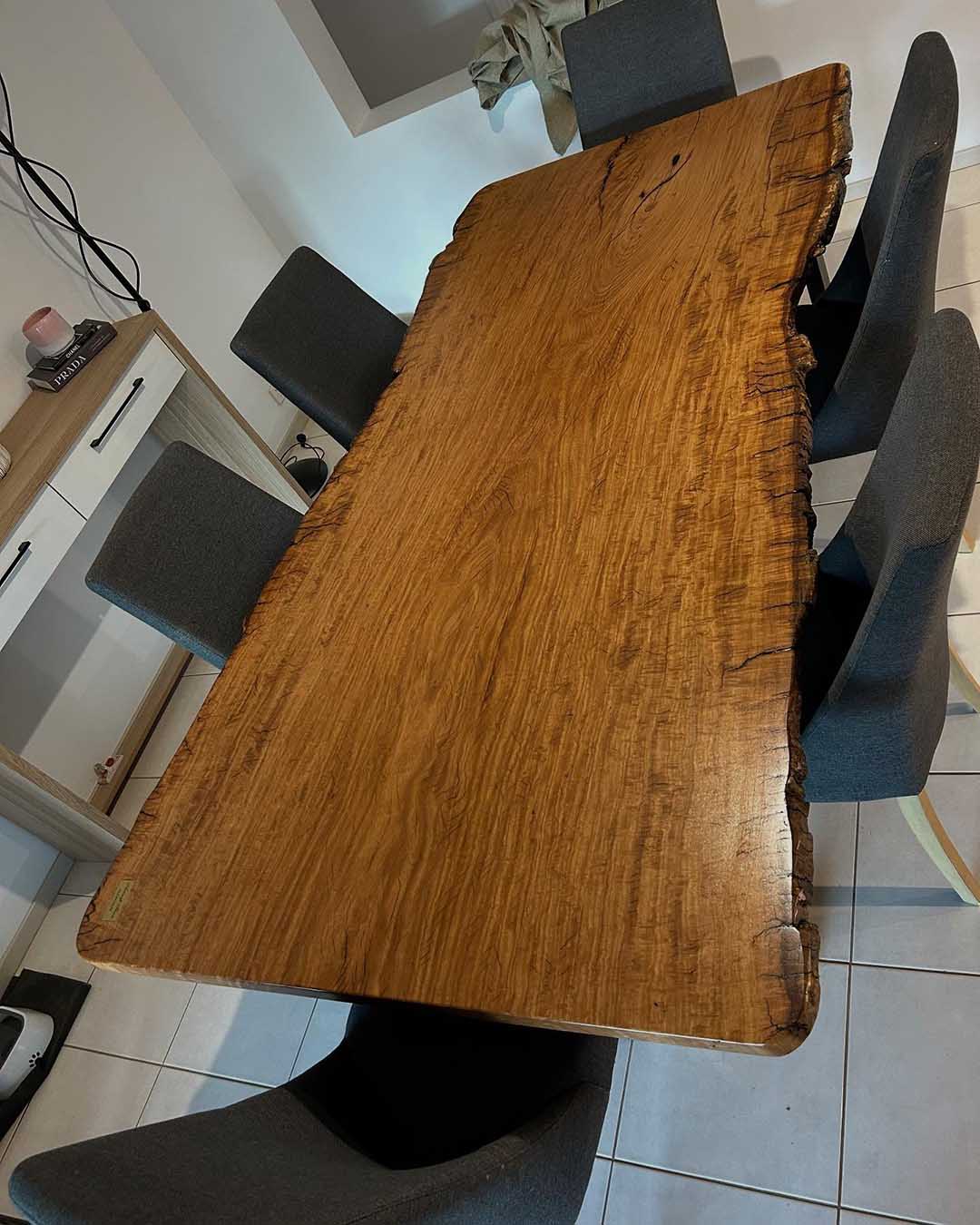 Live-edge timber slab dining table with grey upholstered chairs