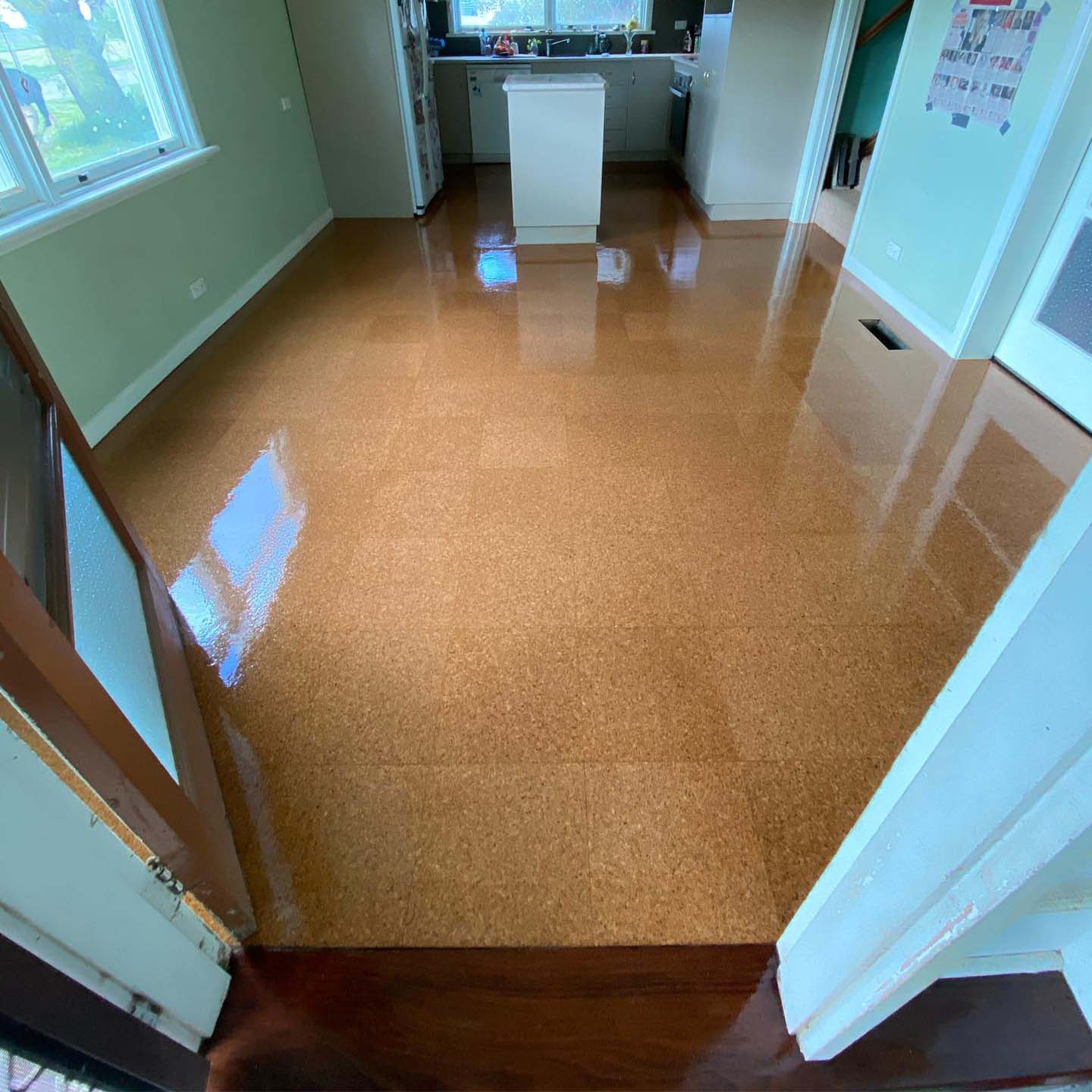 Glossy cork floor in a kitchen, seen from the doorway